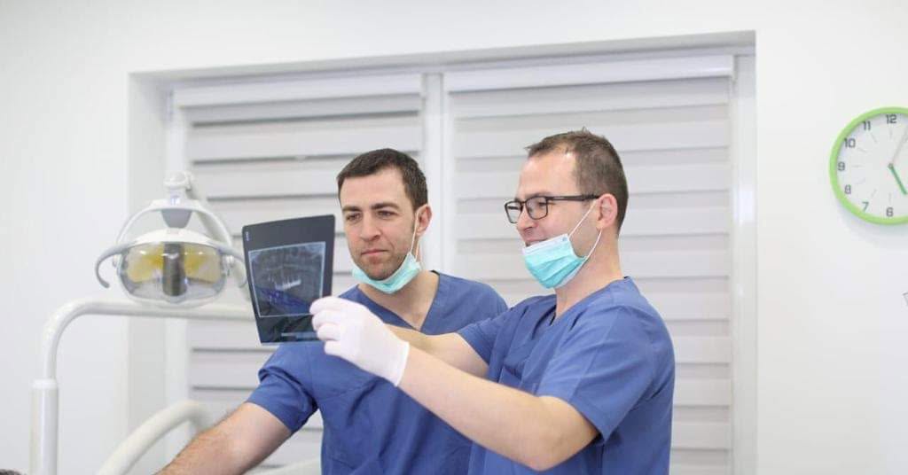 Dentists at mySmile reviewing a panoramic dental radiograph