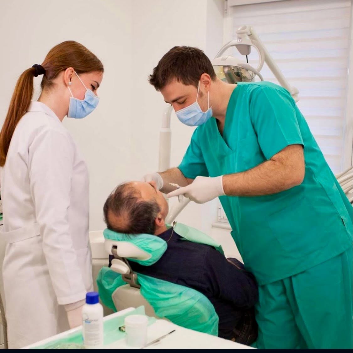 Dr. Genti Memi and a dental assistant treating a patient in the mySmile studio, Tirana