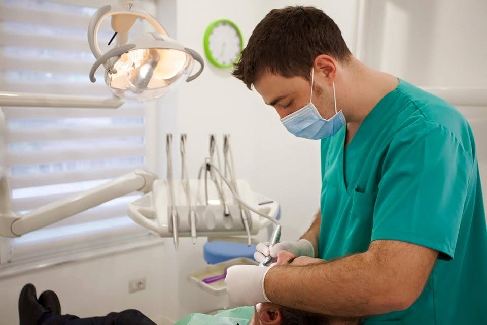 Dr. Genti Memi, founder of mySmile Dental & Aesthetic Clinic in Tirana, treating a patient